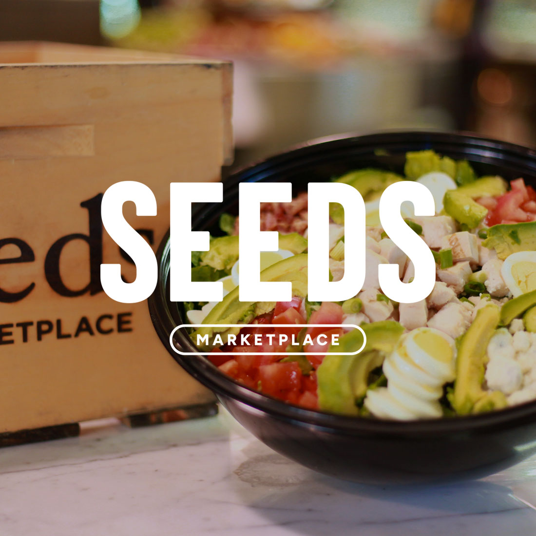 Seeds Marketplace logo over delicious food