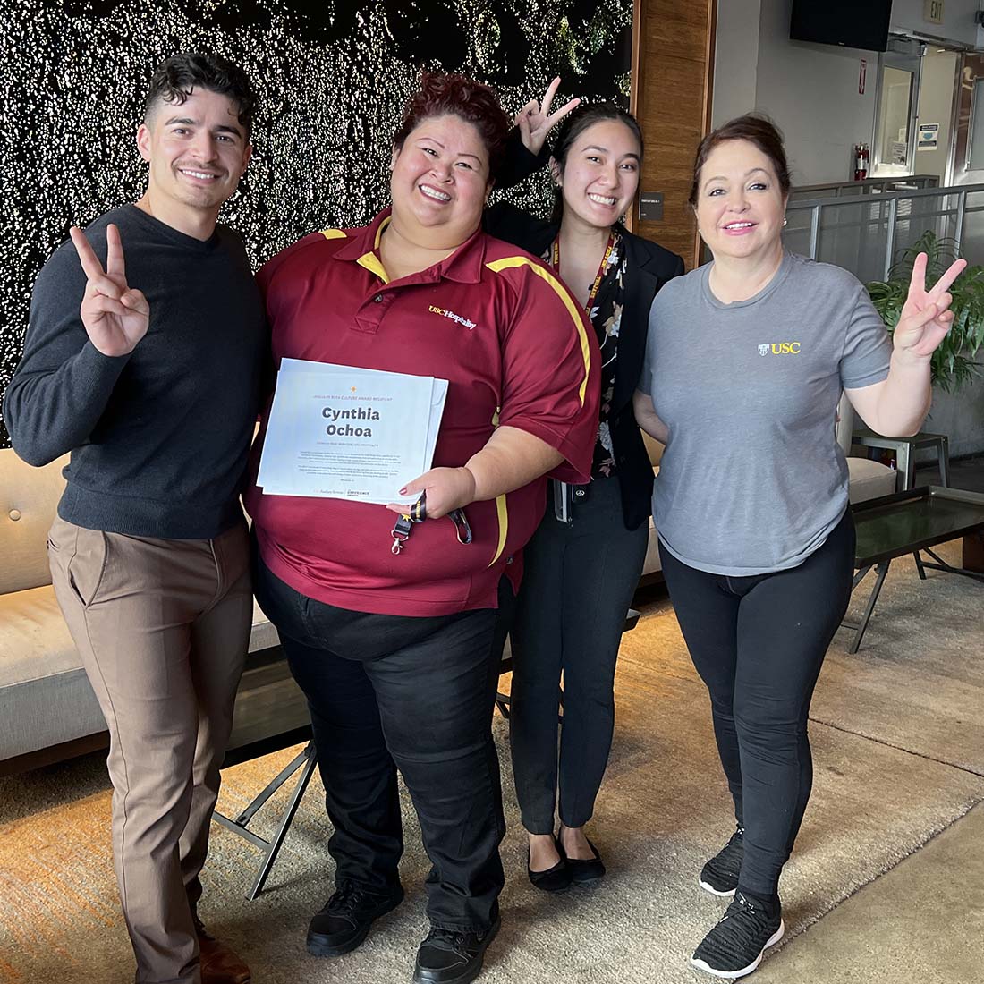 Employees giving the victory sign.